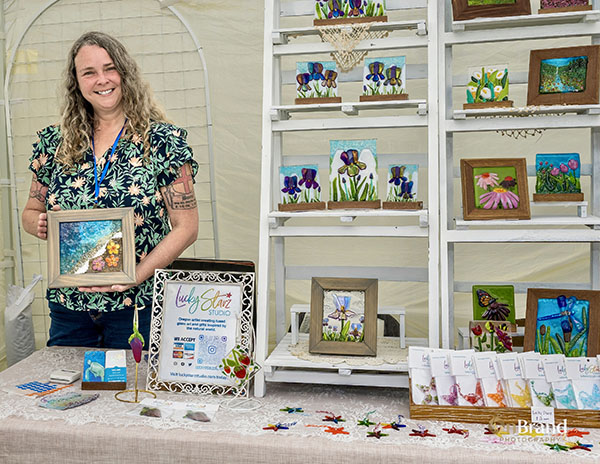 Woman in art booth with glass art